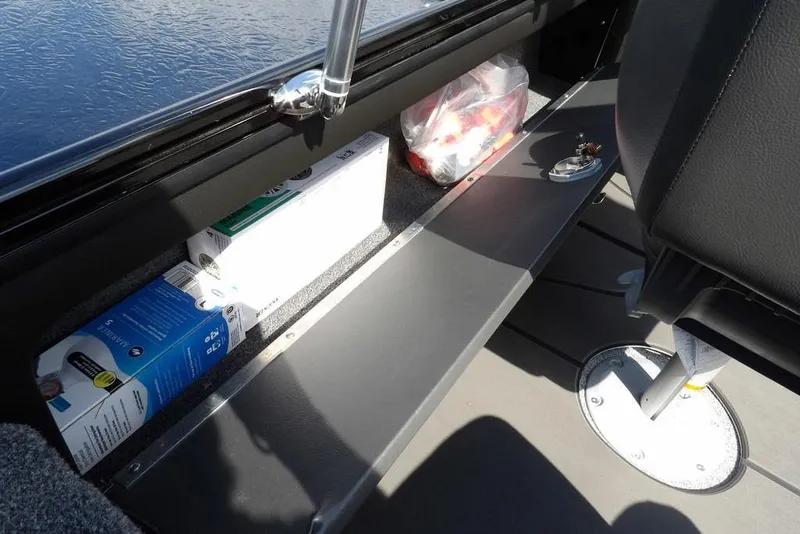 Slide: The Image of Storage compartment in 2026 Lund 2075 Pro-V Sport boat with various items. - 23