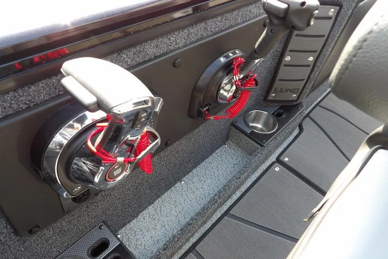 Slide: The Image of Interior of 2026 Lund 2075 Pro-V Sport boat with control panel and cup holder. - 29