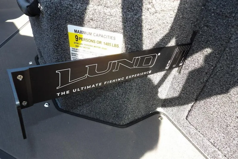 Slide: The Image of 2026 Lund 2075 Pro-V Sport boat interior with capacity label and branding. - 31