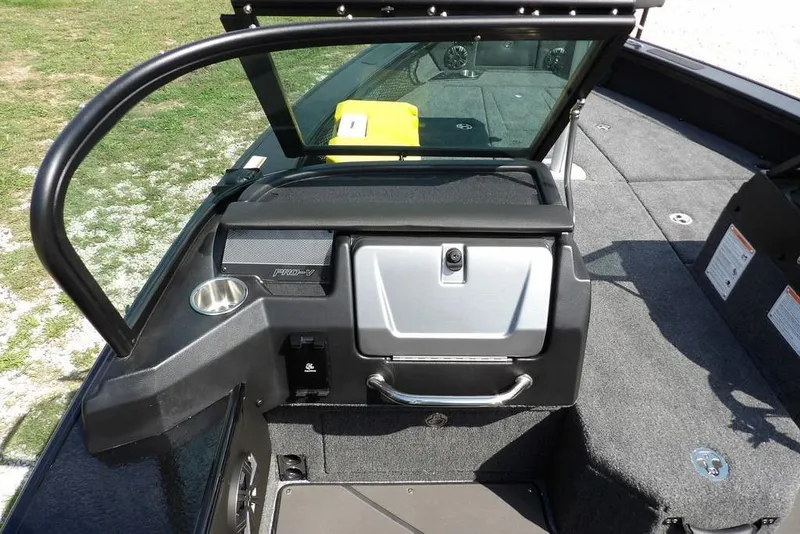 Slide: The Image of 2026 Lund 2075 Pro-V Sport boat interior with windshield and storage compartment. - 33