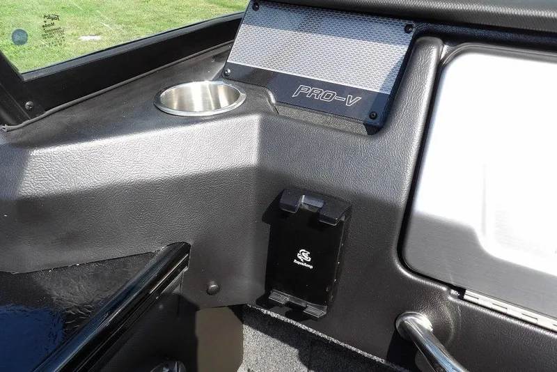 Slide: The Image of Interior of 2026 Lund 2075 Pro-V Sport boat with cup holder and Pro-V branding. - 37