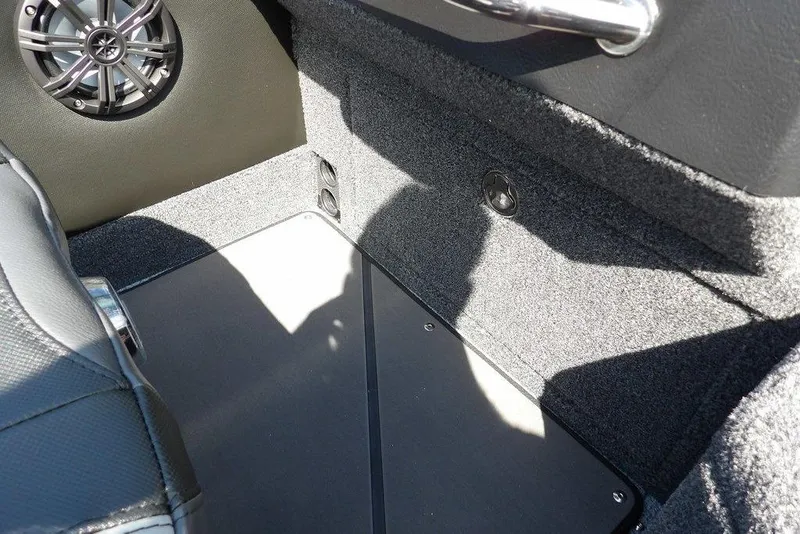 Slide: The Image of Interior of 2026 Lund 2075 Pro-V Sport boat, featuring speaker and carpeted flooring. - 39