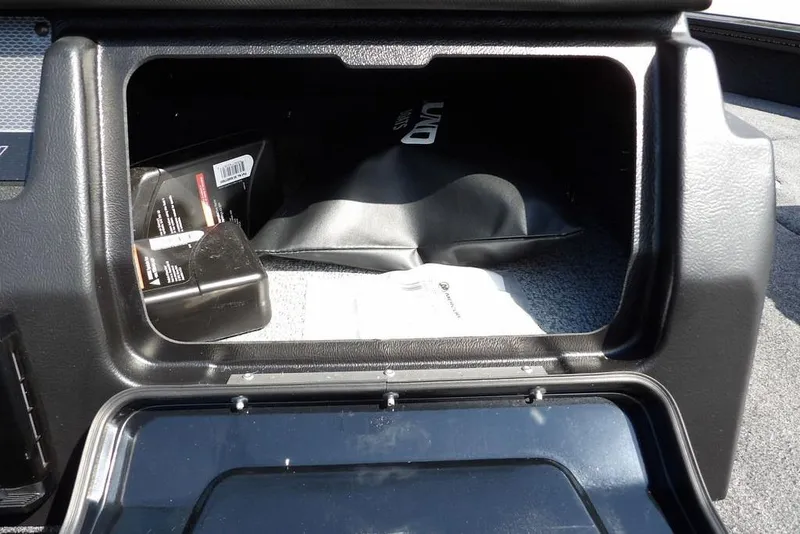 Slide: The Image of Storage compartment in 2026 Lund 2075 Pro-V Sport boat, containing manuals and accessories. - 41