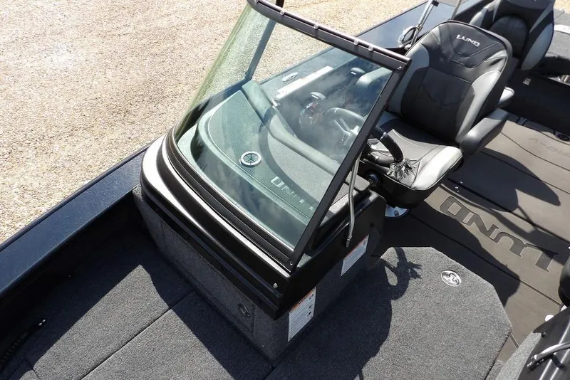 Slide: The Image of 2026 Lund 2075 Pro-V Sport boat interior with windshield and seating. - 42