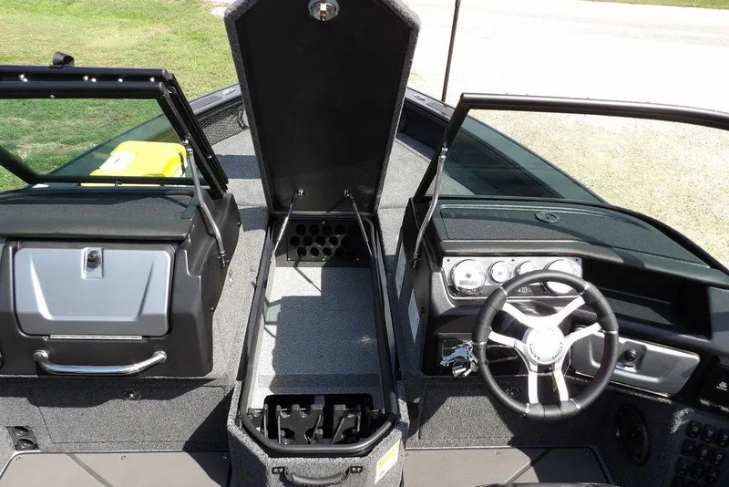 Slide: The Image of 2026 Lund 2075 Pro-V Sport boat interior with steering wheel and storage compartments. - 45