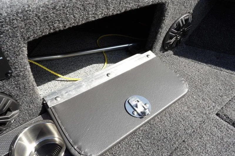 Slide: The Image of 2026 Lund 2075 Pro-V Sport boat interior storage compartment with speaker and cup holder. - 53