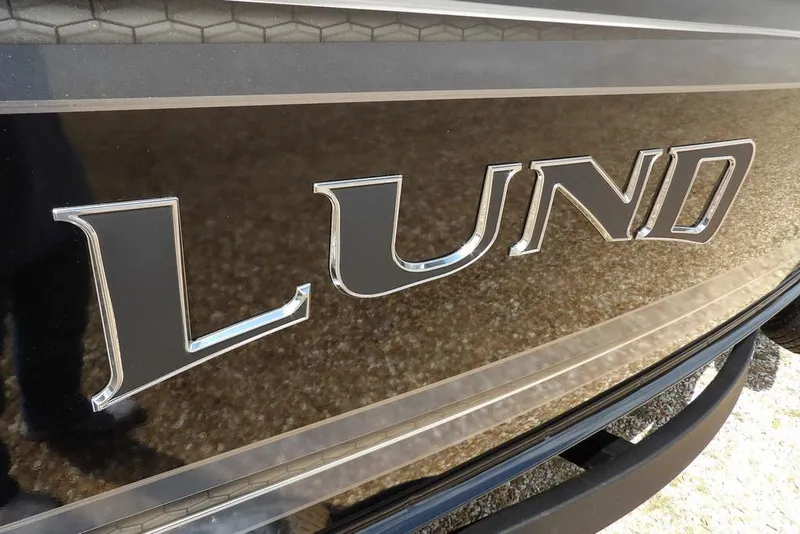 Slide: The Image of Close-up of 2026 Lund 2075 Pro-V Sport boat logo on metallic surface. - 57