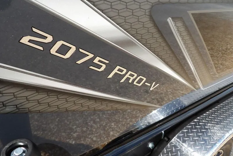 Slide: The Image of 2026 Lund 2075 Pro-V Sport boat logo with textured background. - 61
