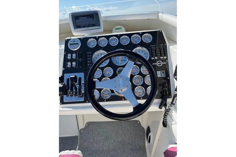 Slide: The Image of Cockpit of a 1997 Fountain 42 Lightning boat with steering wheel and gauges. - 3