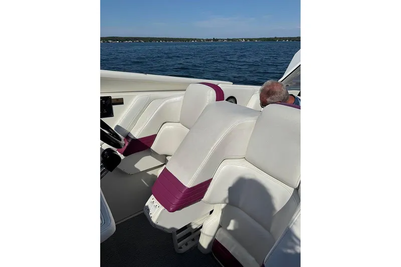 Slide: The Image of 1997 Fountain 42 Lightning boat interior with white and purple seating on a sunny day. - 4