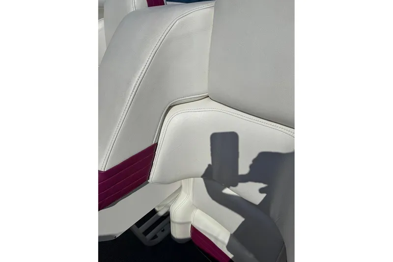 Slide: The Image of White and maroon boat seat in 1997 Fountain 42 Lightning, with shadow of a hand. - 5