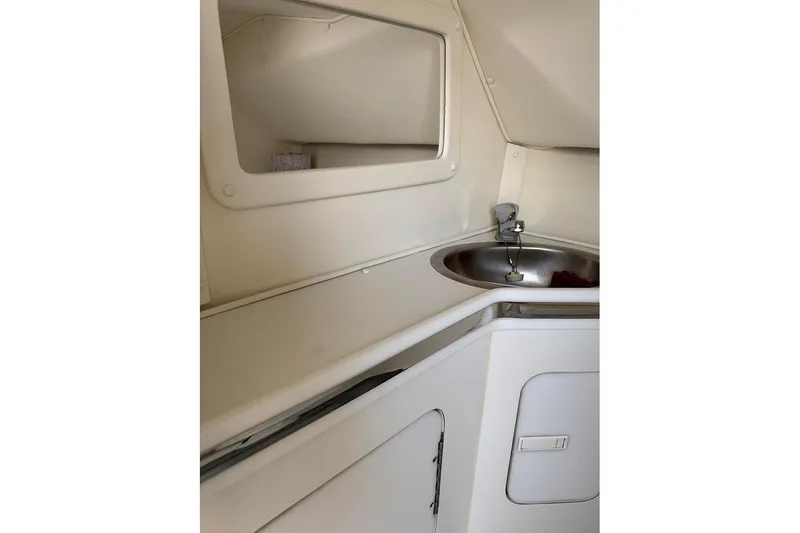 Slide: The Image of 1997 Fountain 42 Lightning boat interior with sink and storage area. - 6