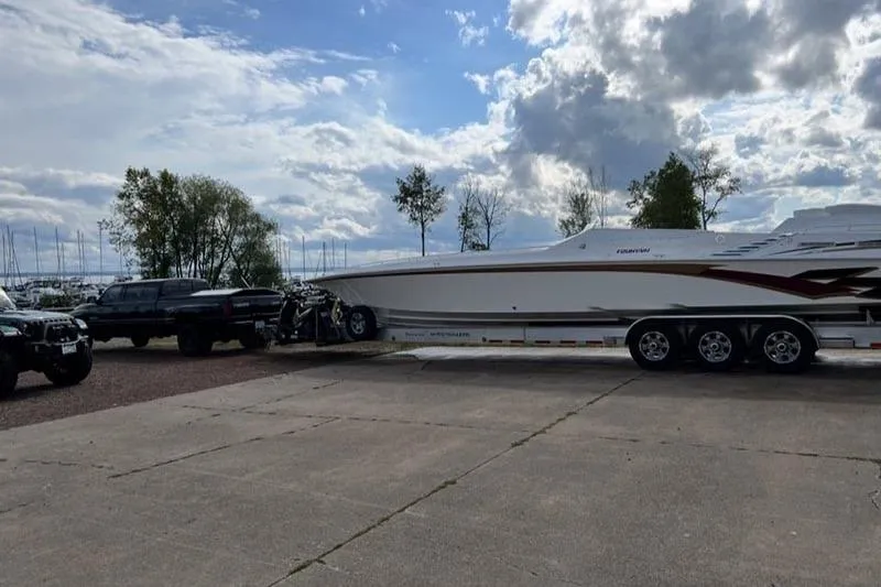 Slide: The Image of 1997 Fountain 42 Lightning boat on trailer, parked outdoors under cloudy sky. - 8
