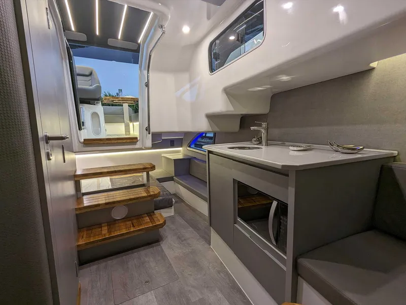 Slide: The Image of Modern interior of 2025 Hanover 347 Inboard boat with sleek kitchen and wooden steps. - 19