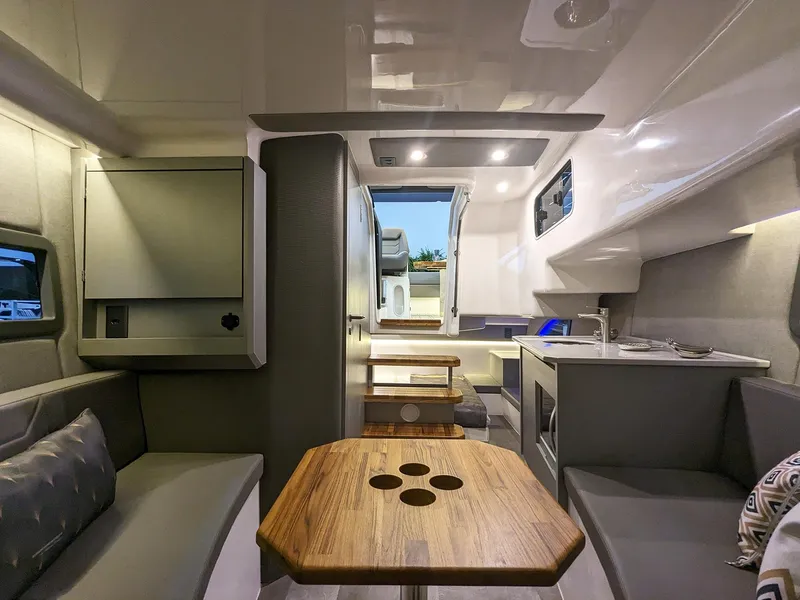 Slide: The Image of Modern interior of 2025 Hanover 347 Inboard boat with sleek seating and wooden table. - 20
