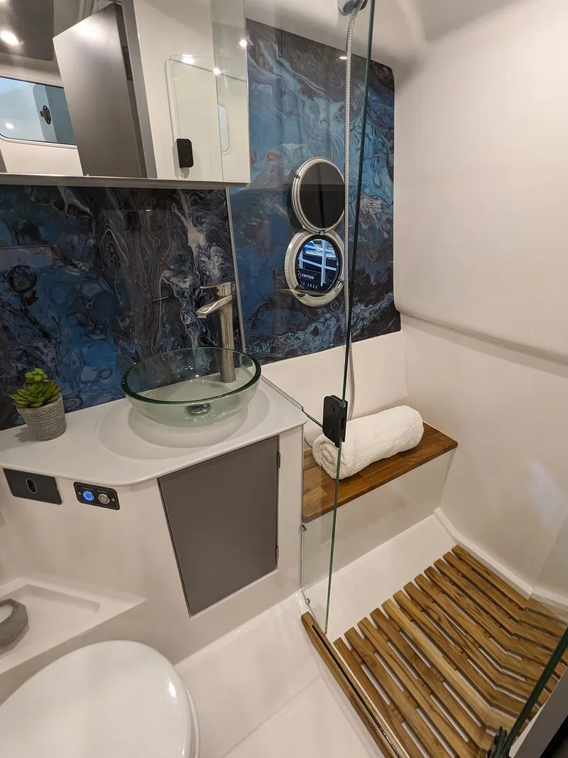 Slide: The Image of Modern bathroom in 2025 Hanover 347 Inboard boat with glass sink and wooden accents. - 25