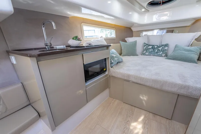 Slide: The Image of Luxurious interior of Hanover 347 yacht, featuring a cozy bed, kitchenette, and modern design. - 28