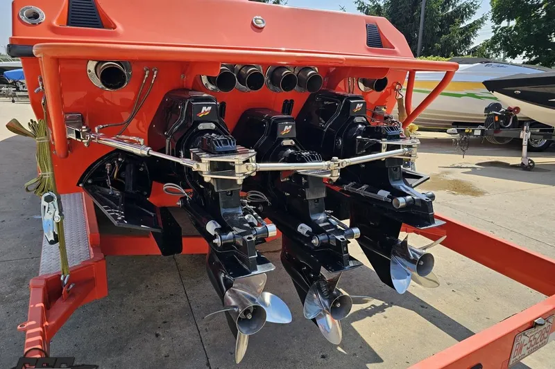 Slide: The Image of 1995 Hustler 40 Fiore boat with dual outboard engines on trailer. - 11