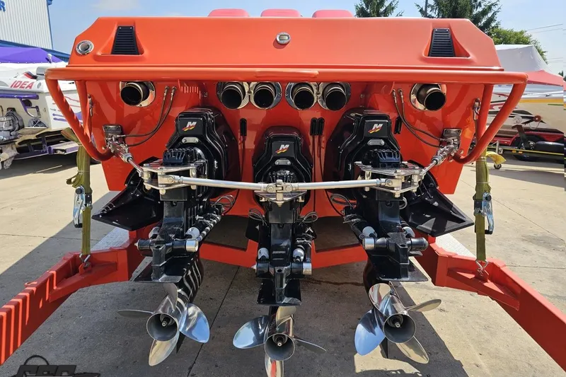 Slide: The Image of Rear view of 1995 Hustler 40 Fiore boat with triple outboard engines. - 13