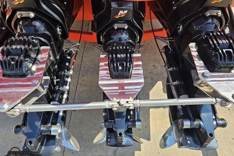 Slide: The Image of Triple outboard motors on a 1995 Hustler 40 Fiore boat, showcasing powerful propulsion. - 14