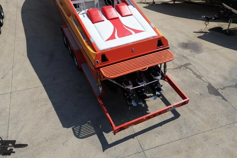 Slide: The Image of 1995 Hustler 40 Fiore boat on trailer, showcasing vibrant red and white design. - 15