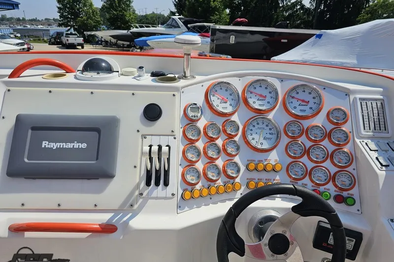 Slide: The Image of Control panel of a 1995 Hustler 40 Fiore boat with Raymarine navigation system. - 26