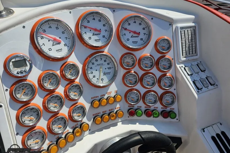 Slide: The Image of Dashboard of a 1995 Hustler 40 Fiore boat with multiple gauges and controls. - 28
