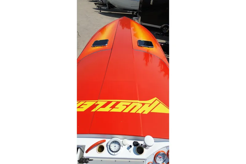 Slide: The Image of 1995 Hustler 40 Fiore speedboat with vibrant orange and yellow design. - 31