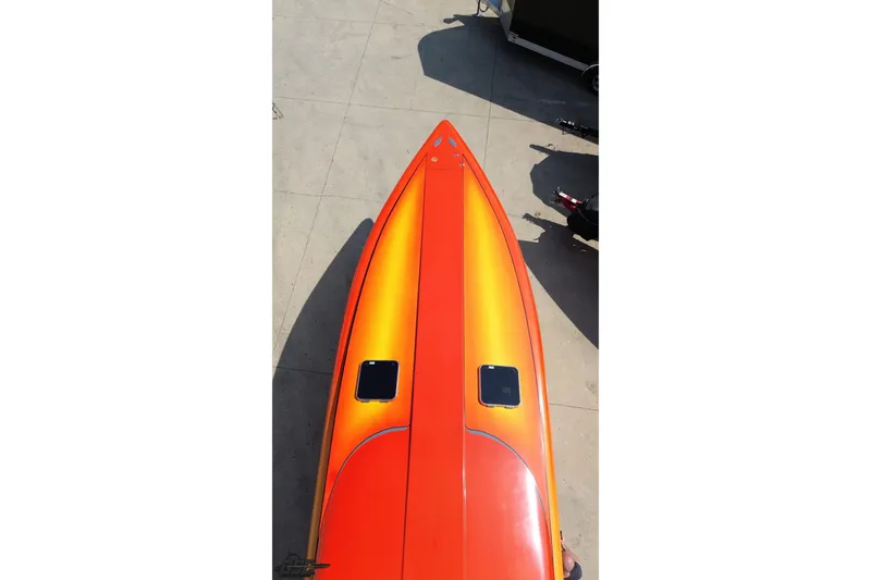 Slide: The Image of Orange 1995 Hustler 40 Fiore boat viewed from above on concrete surface. - 33