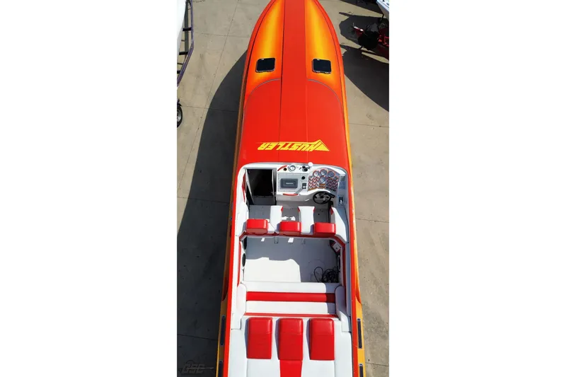 Slide: The Image of 1995 Hustler 40 Fiore speedboat with vibrant orange and red design, viewed from above. - 35