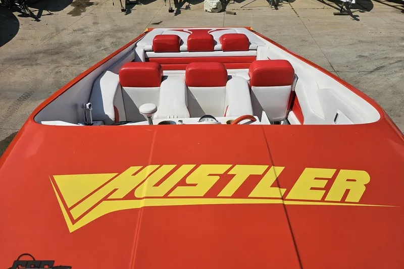 Slide: The Image of 1995 Hustler 40 Fiore speedboat with red and white interior, docked on concrete. - 39
