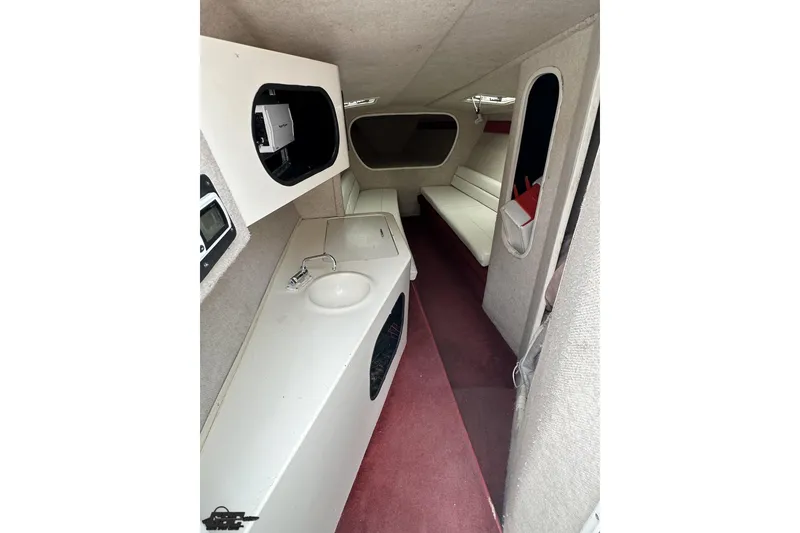 Slide: The Image of Interior of a 1995 Hustler 40 Fiore boat with seating and sink. - 44