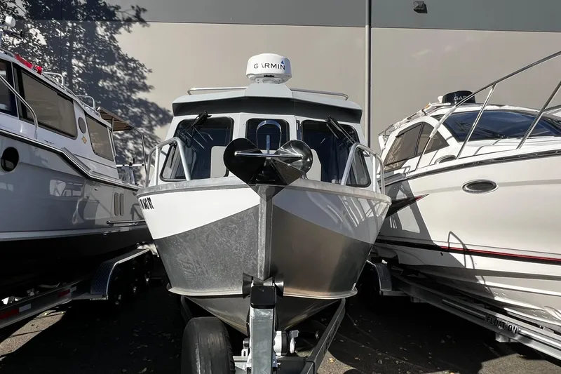 Slide: The Image of 2018 Hewescraft 220 Ocean Pro ET HT boat on trailer, flanked by other boats. - 1