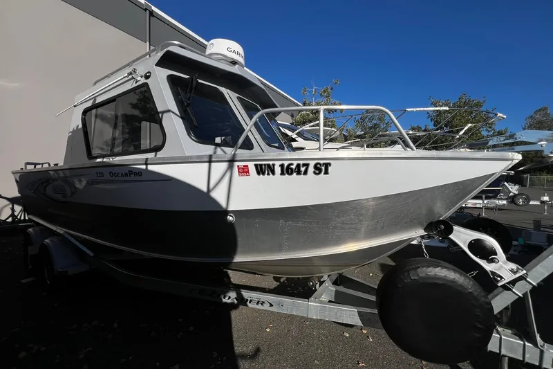 Slide: The Image of 2018 Hewescraft 220 Ocean Pro ET HT boat on trailer, parked outdoors. - 2