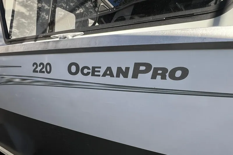Slide: The Image of 2018 Hewescraft 220 Ocean Pro ET HT boat side view with logo. - 4