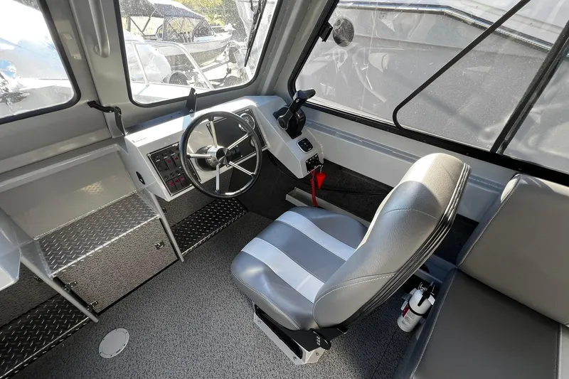 Slide: The Image of 2018 Hewescraft 220 Ocean Pro ET HT interior with steering wheel and captain's seat. - 7