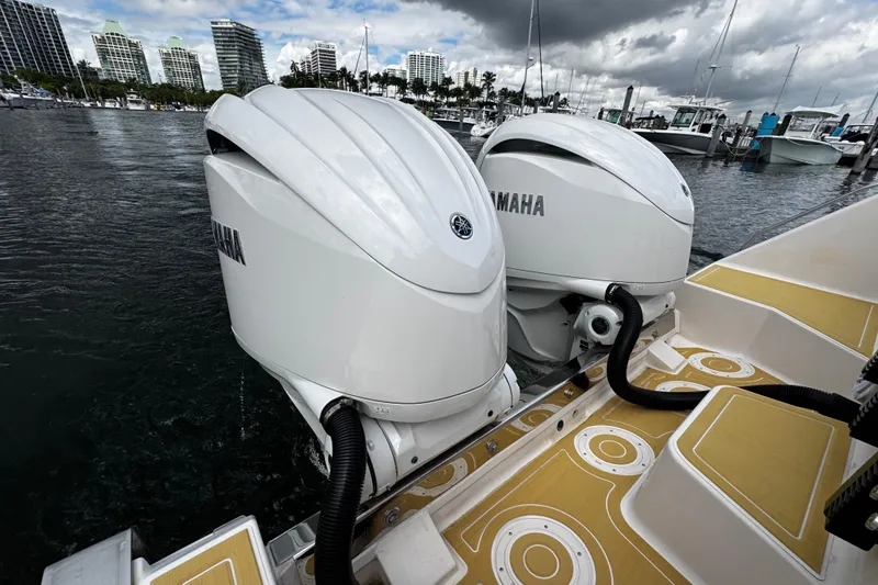Slide: The Image of Twin Yamaha outboard engines on a 2001 Grady-White Express 330 boat at a marina. - 12