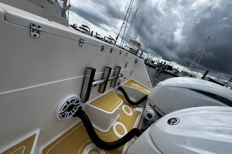 Slide: The Image of 2001 Grady-White Express 330 boat with dual engines, docked under stormy skies. - 15