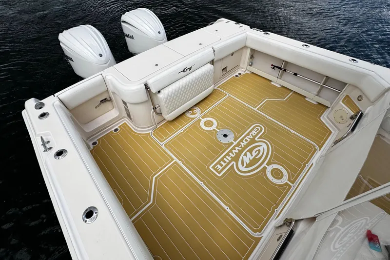 Slide: The Image of 2001 Grady-White Express 330 boat deck with Yamaha engines, featuring custom flooring. - 16