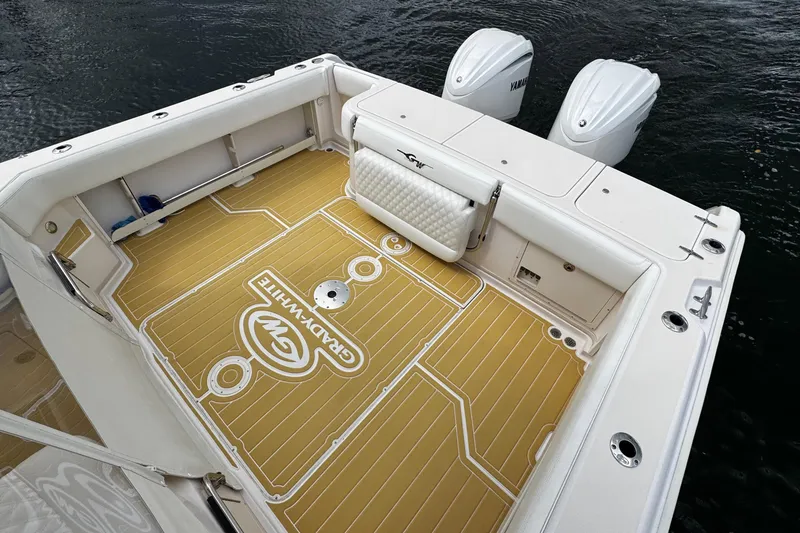 Slide: The Image of 2001 Grady-White Express 330 boat deck with Yamaha engines, featuring custom flooring. - 17