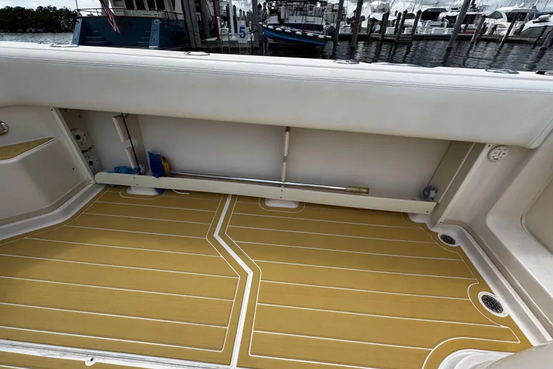 Slide: The Image of 2001 Grady-White Express 330 boat interior with teak flooring and storage compartment. - 20