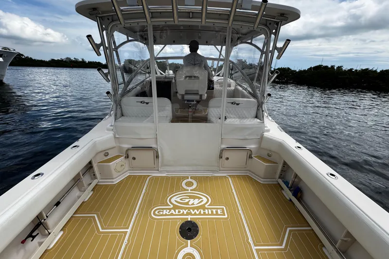 Slide: The Image of 2001 Grady-White Express 330 boat on water, featuring spacious deck and seating. - 22