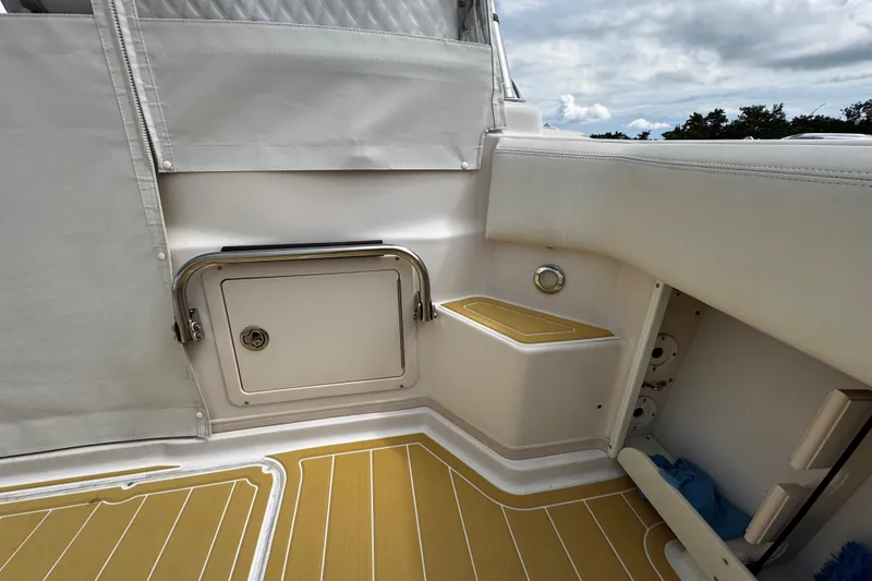 Slide: The Image of 2001 Grady-White Express 330 boat interior with storage compartment and cushioned seating. - 23