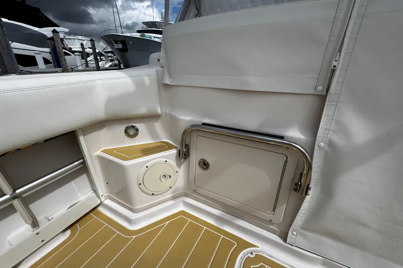 Slide: The Image of 2001 Grady-White Express 330 boat interior with storage compartment and seating. - 24