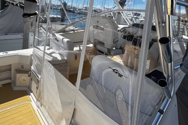 Slide: The Image of 2001 Grady-White Express 330 boat interior with seating and helm, docked at marina. - 26
