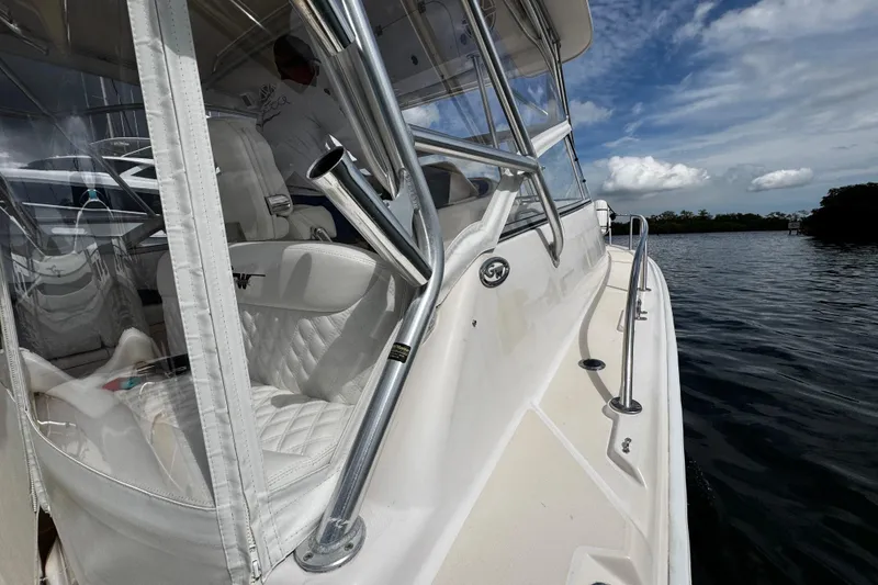 Slide: The Image of 2001 Grady-White Express 330 boat on water, featuring sleek design and white interior. - 27
