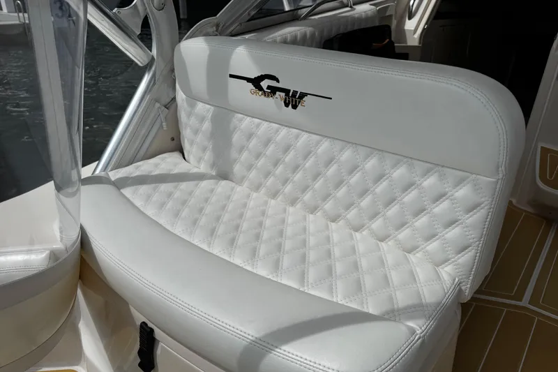 Slide: The Image of 2001 Grady-White Express 330 boat seat with quilted white upholstery. - 28
