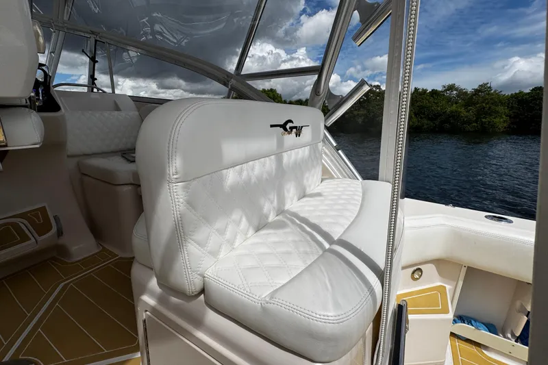 Slide: The Image of 2001 Grady-White Express 330 boat interior with white seating and scenic water view. - 29