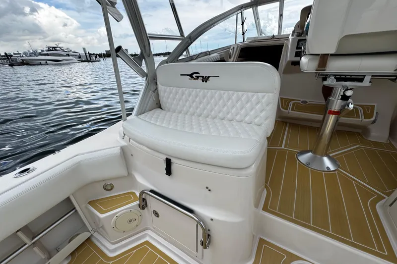 Slide: The Image of 2001 Grady-White Express 330 boat interior with white seating and wood-patterned flooring. - 30