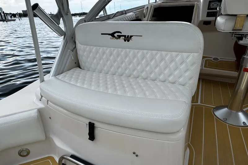 Slide: The Image of White cushioned seating on 2001 Grady-White Express 330 boat, docked by the water. - 31